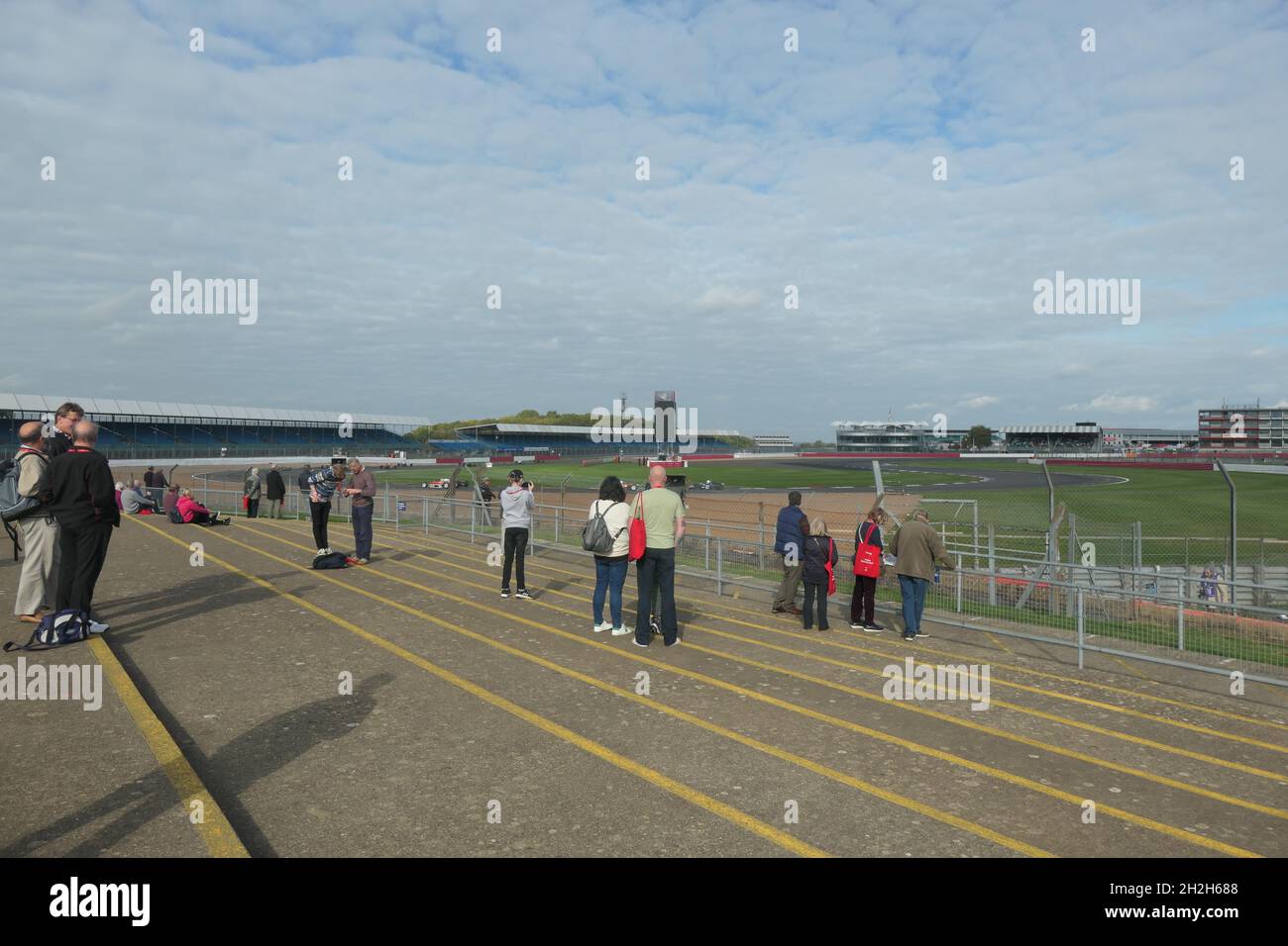 Silverstone motor racing circuit Northamptonshire UK watching cars racing famous Grande Prix barriers race waiting steps views history historic racing Stock Photo