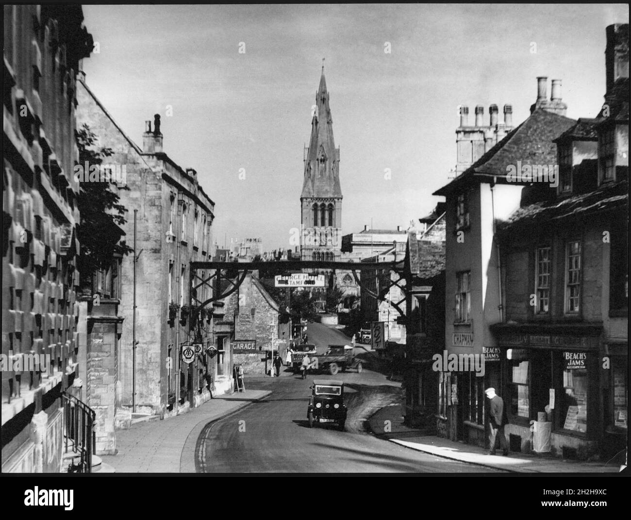High Street St Martin's, Stamford, South Kesteven, Lincolnshire, 1920-1940. A view looking north along High Street St Martin's with the George Hotel in the foreground and the tower of St Mary's Church in the distance. Stock Photo