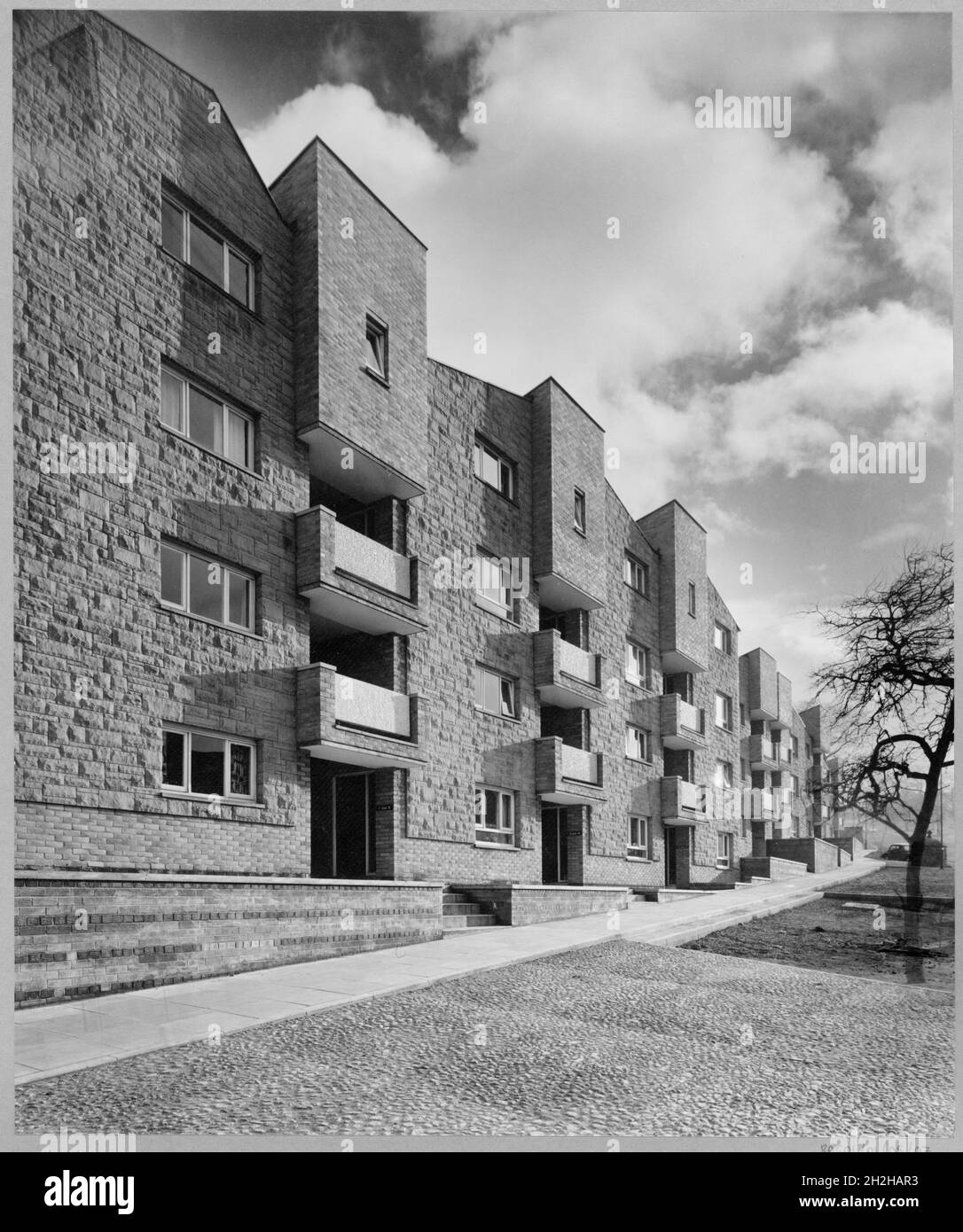 Westgate House, Clayport Street, Alnwick, Northumberland, 1960-1979. Exterior of 7-33 Westgate House, in the parish of Alnwick, Northumberland, facing south along the face of the row of terraced flats, with pedestrian pavement in the foreground. Stock Photo