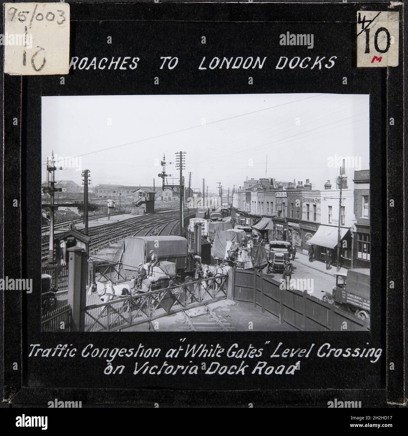 White Gates Level Crossing Canning Town Newham Greater London Authority 19s Vans And Horse Drawn Carts On The White Gates Level Crossing And Traffic Queuing On Victoria Dock Road Alongside The North Woolwich