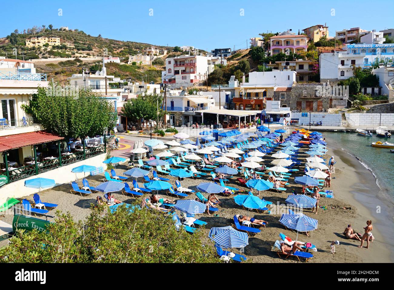 Elevated view the beach with tavernas and shops to the rear, Bali, Crete, Greece, Europe. Stock Photo