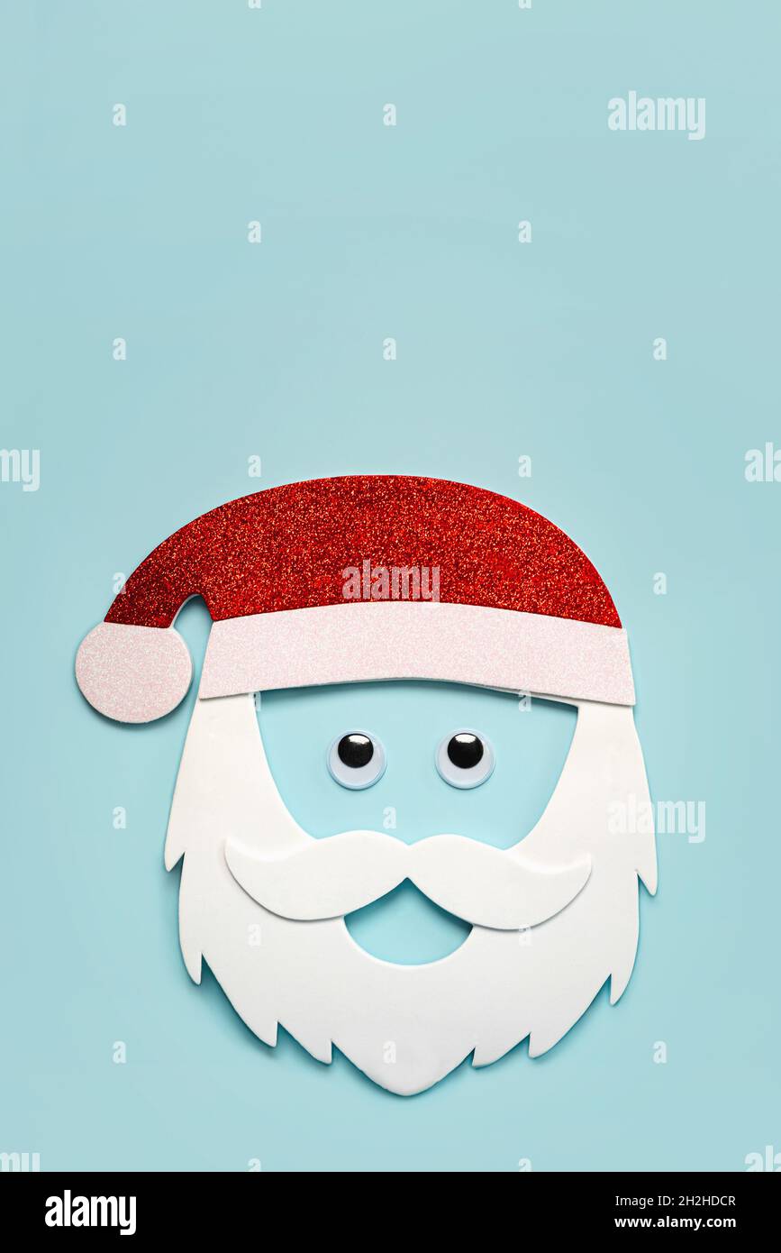 Merry Christmas. Santa claus mask with false eyes and copy space over blue background. Christmas concept background Stock Photo