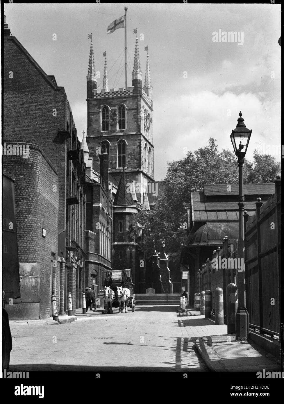 Southwark Cathedral, Montague Close, Southwark, Greater London Authority, 1930s. Looking east along Winchester Street towards the central tower of Southwark Cathedral, showing a horse-drawn cart on the road outside Borough Market to the right. Stock Photo