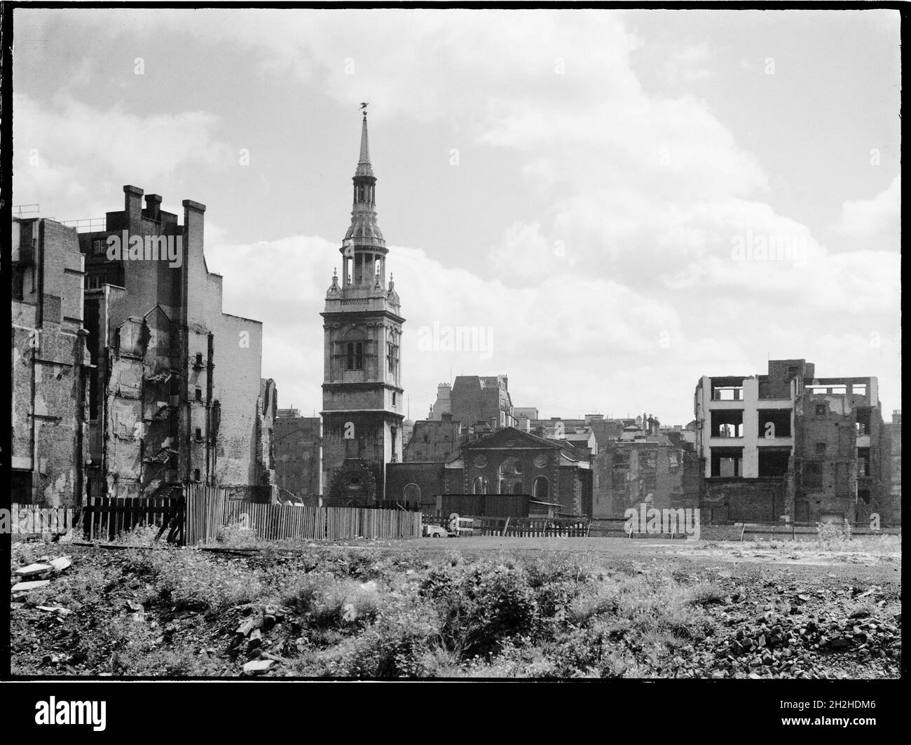 St Mary-le-Bow Church, Cheapside, City and County of the City of London, Greater London Authority, 1941-1945. A view looking east across a bomb damaged landscape towards St Mary-le-Bow Church. St Mary-le-Bow was rebuilt by Christopher Wren after the Great Fire of London in 1666. During the Second World War it was almost destroyed by bombing on 10th May 1941 with incendiary bombs causing a fire which sent the bells in its tower crashing down to the ground. The tower was left standing and restoration of the church began in 1956. Stock Photo