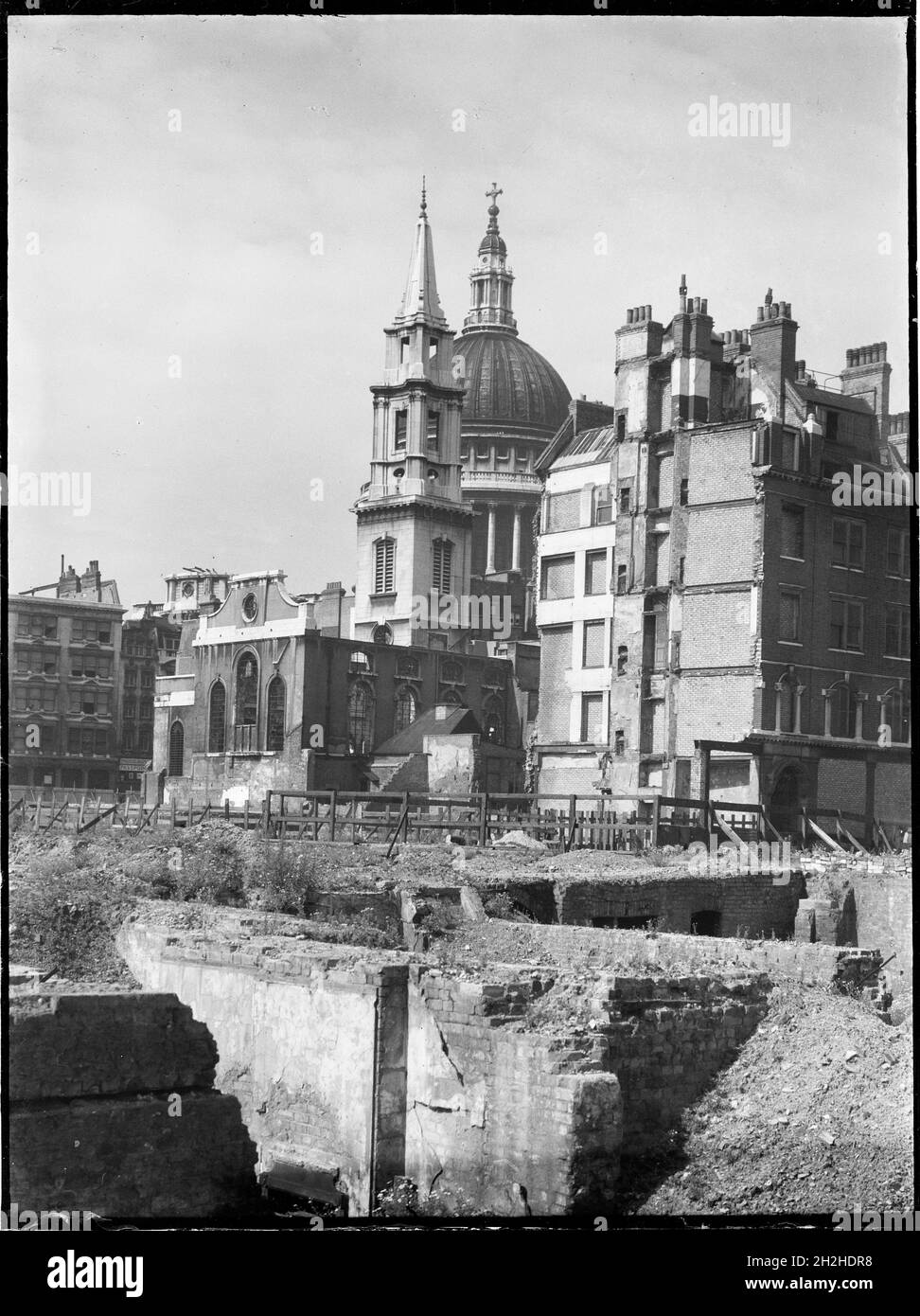 St Paul's Cathedral, St Paul's Churchyard, City of London, City and County of the City of London, Greater London Authority, 1941-1945. A view looking south-west across a bomb damaged landscape towards the Church of St Verdast-alias-Foster with St Paul's Cathedral beyond. The Church of St Verdast-alias-Foster was rebuilt by Christopher Wren after the Great Fire of London in 1666. In the Second World War it was gutted by fire during the Blitz in 1940-41 and was later rebuilt after the war with work starting in 1953. St Paul's Cathedral survived the bombing raids but other buildings in the area w Stock Photo