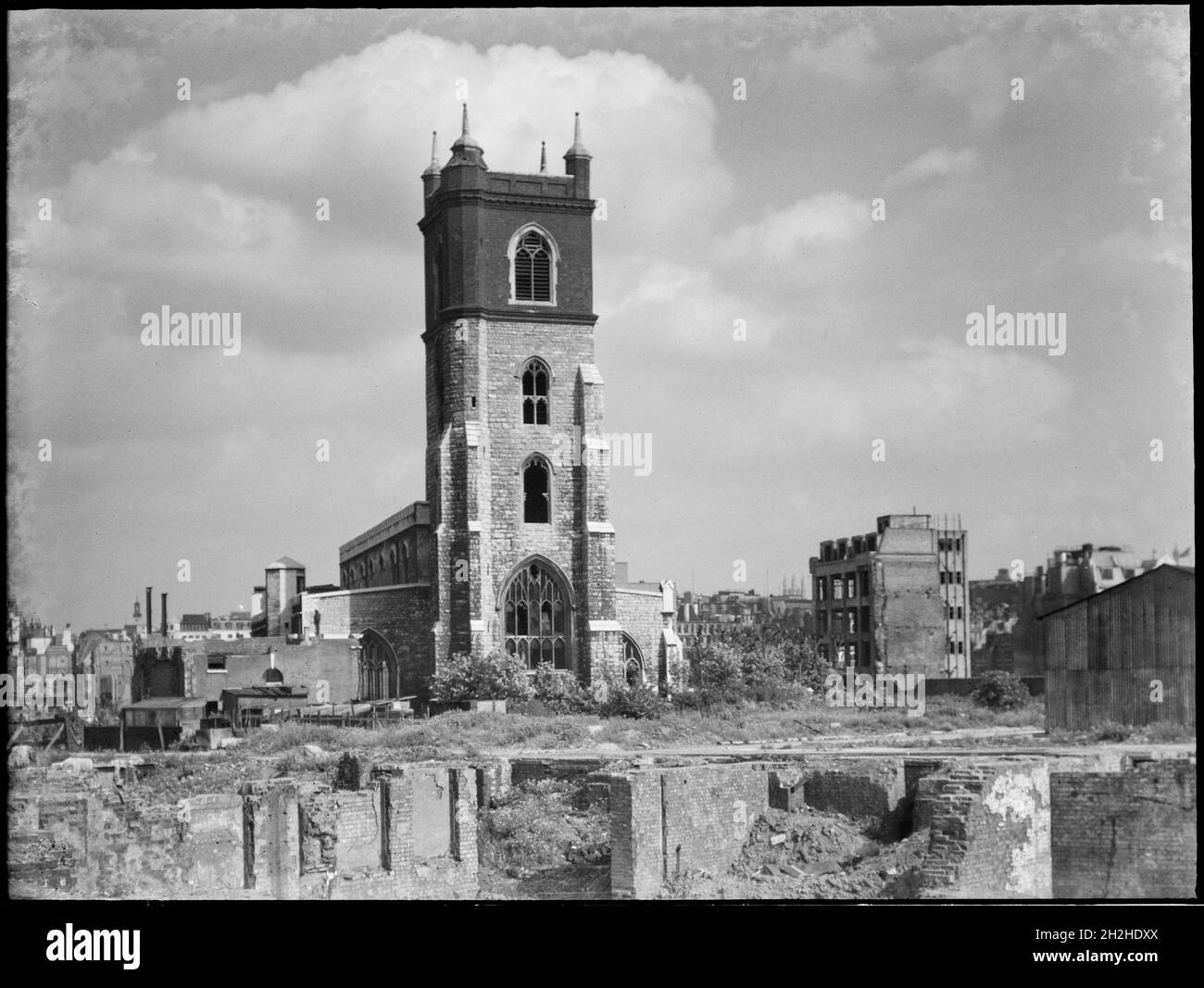 St Giles' Cripplegate, Fore Street, City and County of the City of London, Greater London Authority, 1941-1945. A view looking south-east across a bomb damaged landscape towards St Giles' Cripplegate Church. St Giles' Church was badly damaged during the Blitz in 1941 and the immediate area around it was almost completely destroyed by bombing. The church was rebuilt in the 1950s and now stands at the centre of the Barbican Estate. Stock Photo