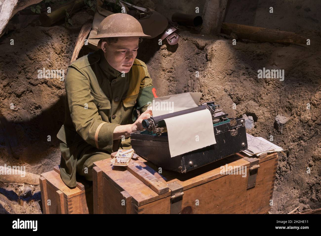 A journalist, reporter, correspondent typing an article in a foxhole during WWI. At the National Museum of the Marine Corps Heritage Center in Virgini Stock Photo