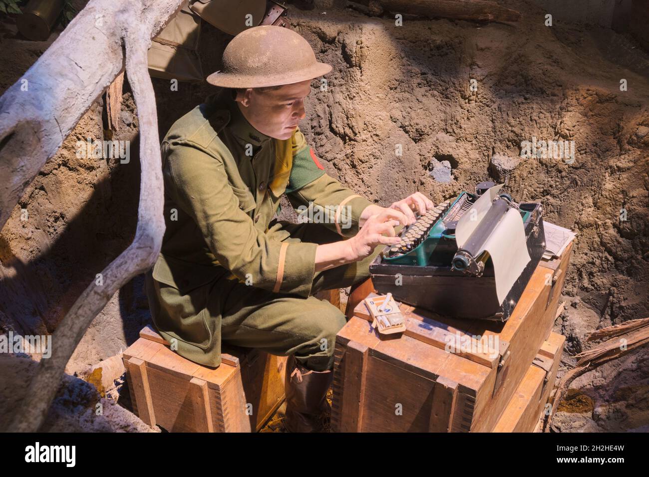 A journalist, reporter, correspondent typing an article in a foxhole during WWI. At the National Museum of the Marine Corps Heritage Center in Virgini Stock Photo