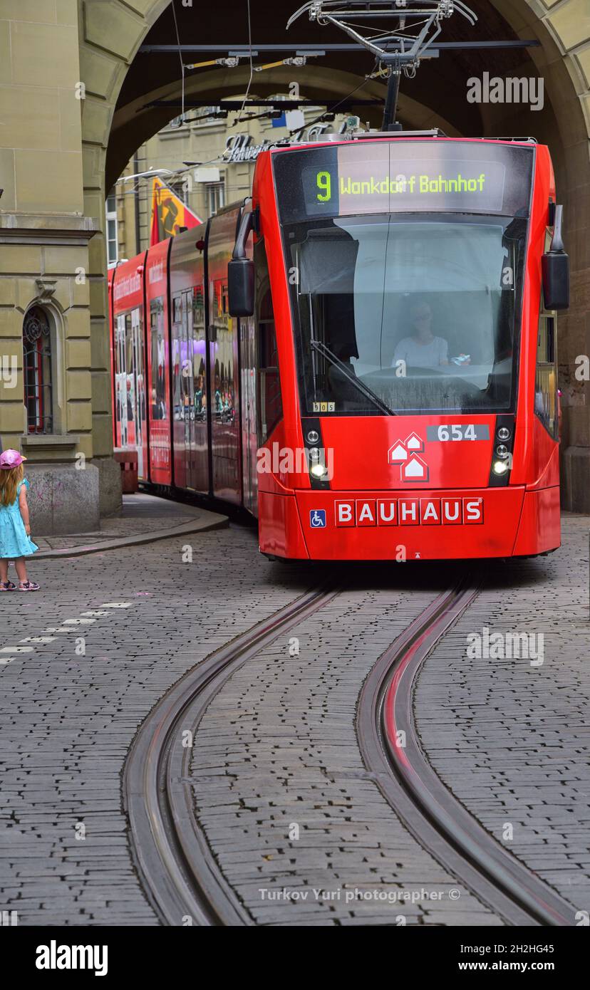 Traditional red trams at the streets of Bern, Switzerland Stock Photo