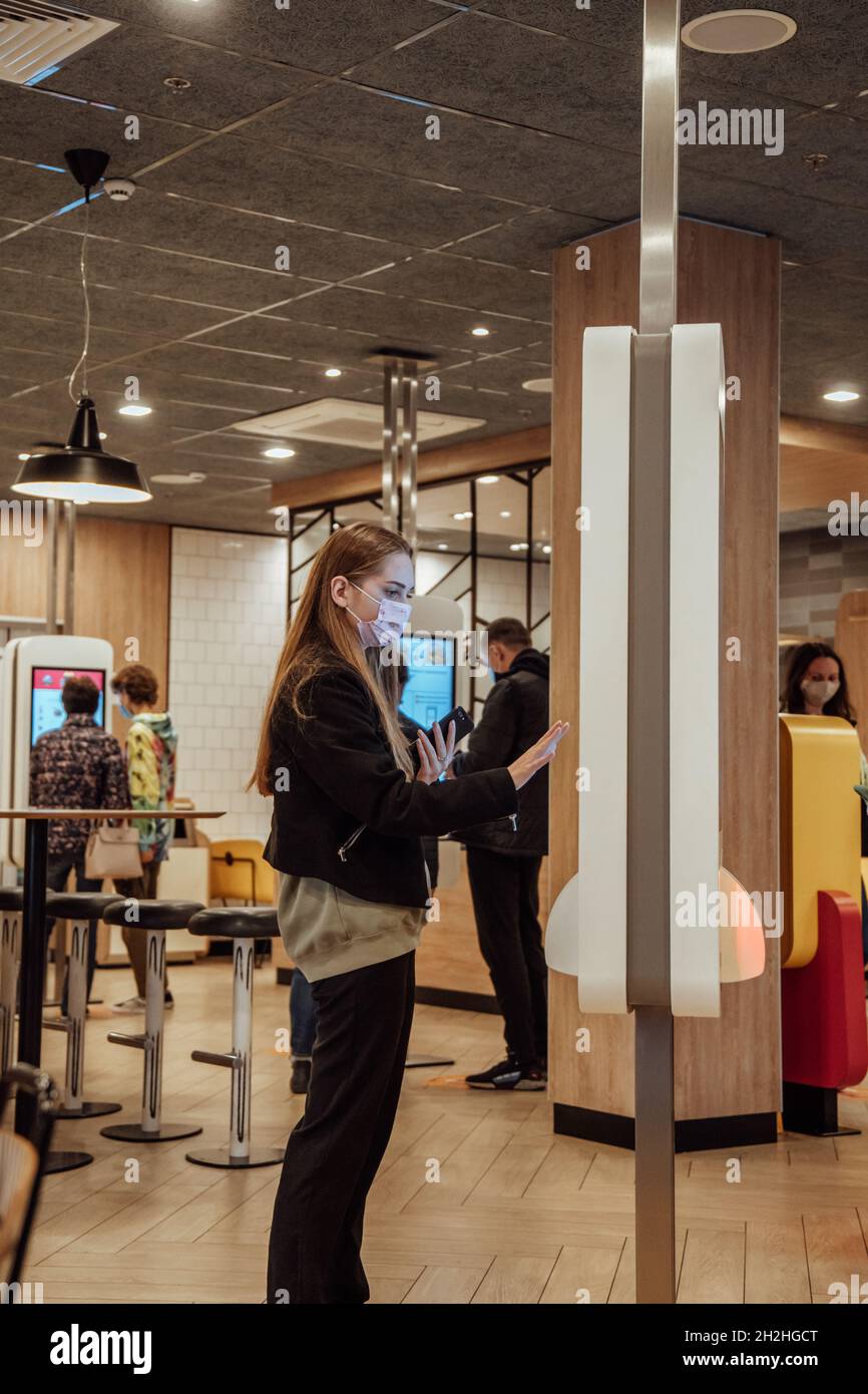 Woman ordering food at McDonald's, vertical image.  Stock Photo
