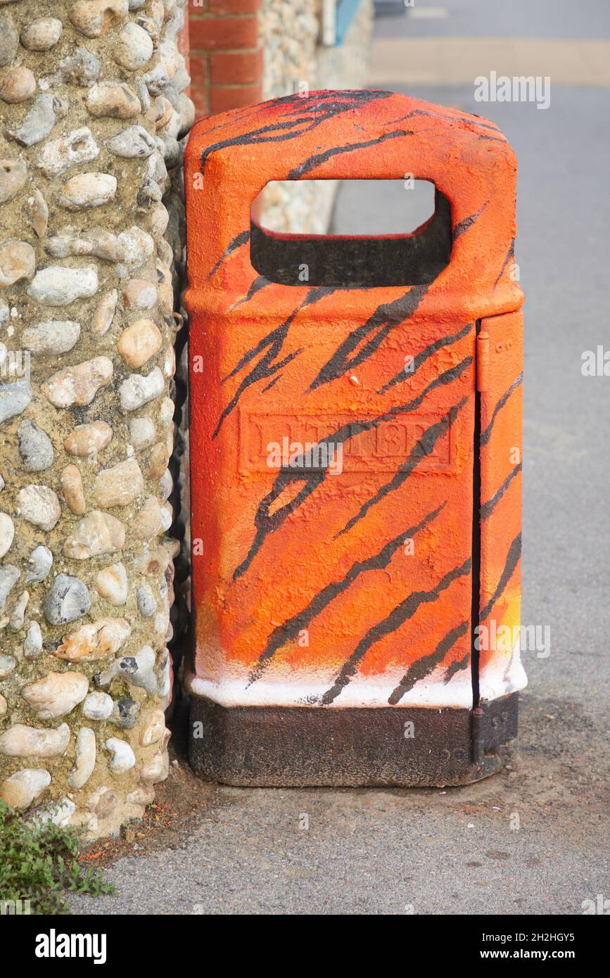Orange litter bin seen outside. Stock Photo