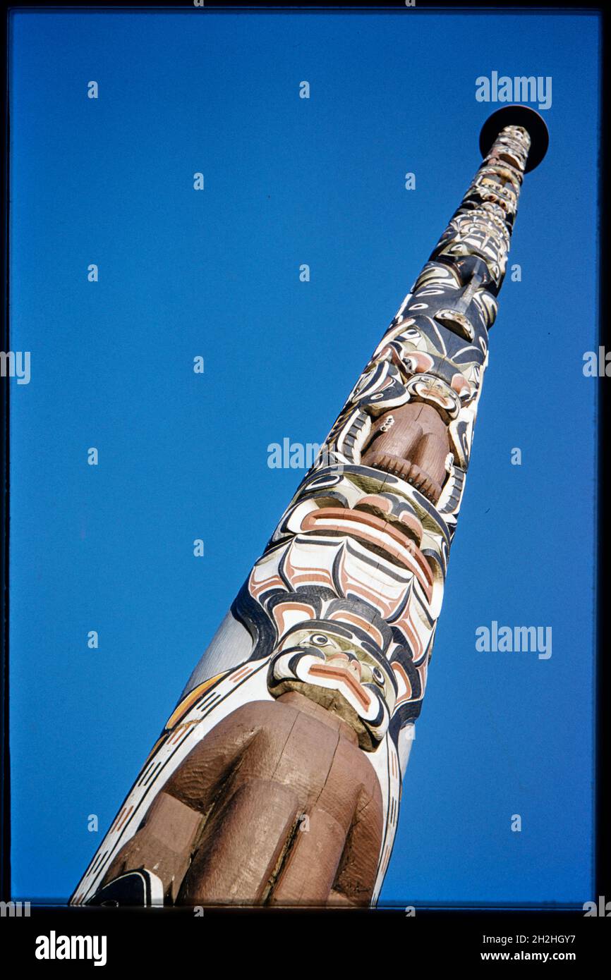 Totem Pole, Windsor Great Park, Runnymede, Surrey, 1959. A view looking up the Totem Pole in Windsor Great Park. The totem pole in Windsor Great Park was presented to Queen Elizabeth II in June 1958 by Chief Mungo Martin of the Kwakiutl or Kwakwaka'wakw or Kwakiutl. The pole is 100 ft high and marks the centenary of British Columbia, which was proclaimed a Crown Colony in 1858 by Queen Victoria. A 600 year old tree was felled in order to create the pole, which was carved by Chief Mungo Martin. A second, identical totem pole was carved and remained in Vancouver, Canada. The totem pole in Windso Stock Photo