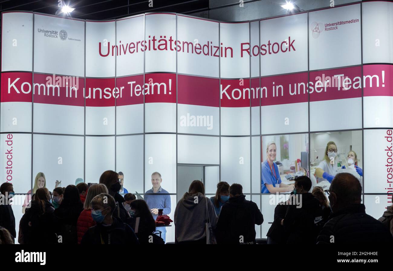 Rostock, Germany. 22nd Oct, 2021. At an information stand of the University Medical Center Rostock young people inform themselves about possibilities of vocational training. At the career orientation fair 'Jobfactory', more than 140 companies, institutions and associations present more than 450 training positions and courses of study in the Hansemesse. Credit: Jens Büttner/dpa-Zentralbild/dpa/Alamy Live News Stock Photo