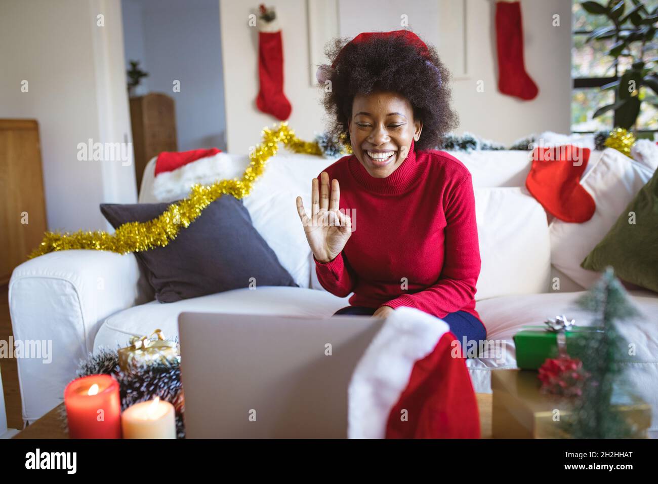 Happy african american woman in santa hat making tablet christmas video call Stock Photo