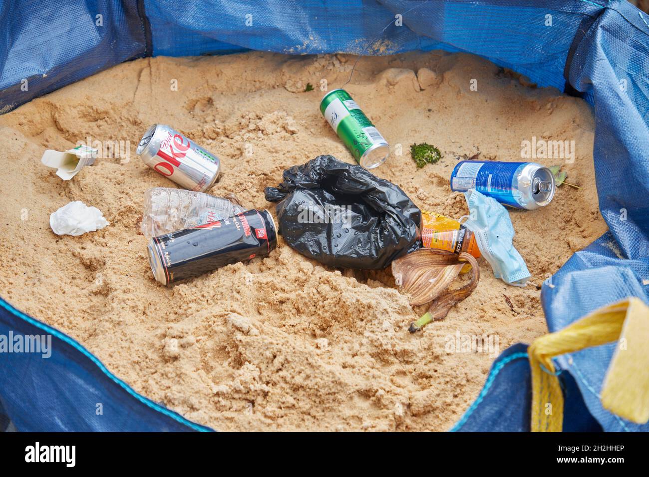 Rubbish thrown on sand. Stock Photo