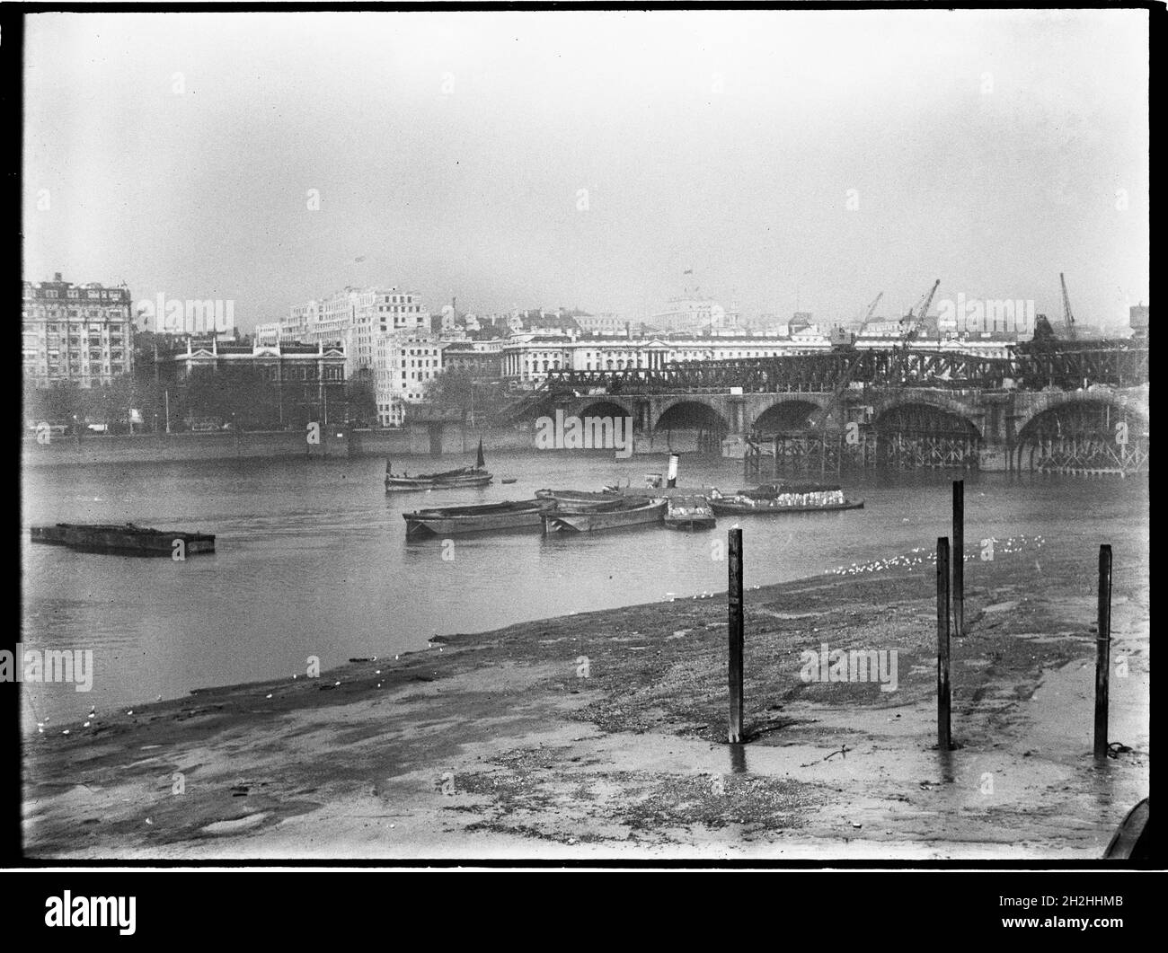 Demolition of Waterloo Bridge, Lambeth, Greater London Authority, 1936. A view looking north-east across the River Thames showing the old Waterloo Bridge under demolition. The Waterloo Bridge was designed by John Rennie and opened in 1817. It was demolished in the 1930s with another bridge replacing it in the 1940s. Stock Photo