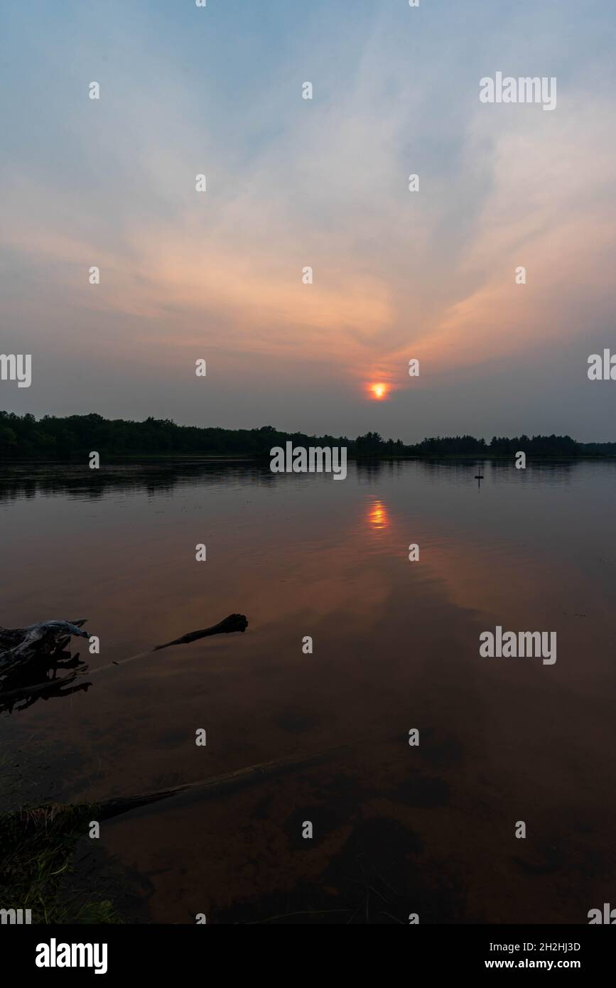 Beautiful sunset on the river bank creating a beautiful natural light ...