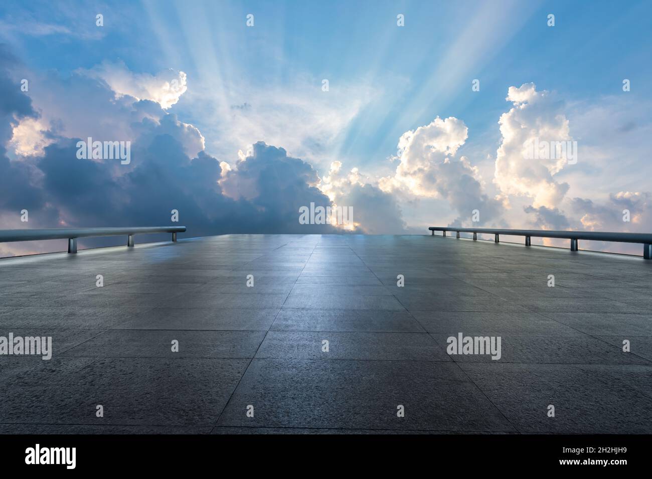 Empty square floor and blue sky with white clouds at sunset. Stock Photo