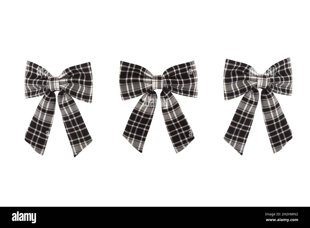 Closeup of three black and white checkered bow ties isolated on a white ...