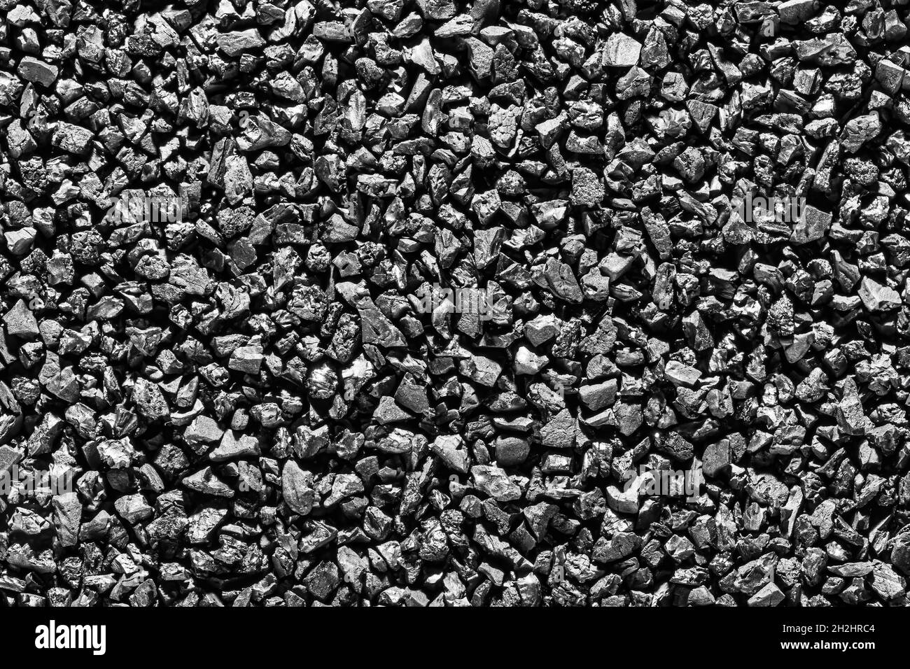 Close-up of black activated carbon texture. Coconut charcoal. Stock Photo