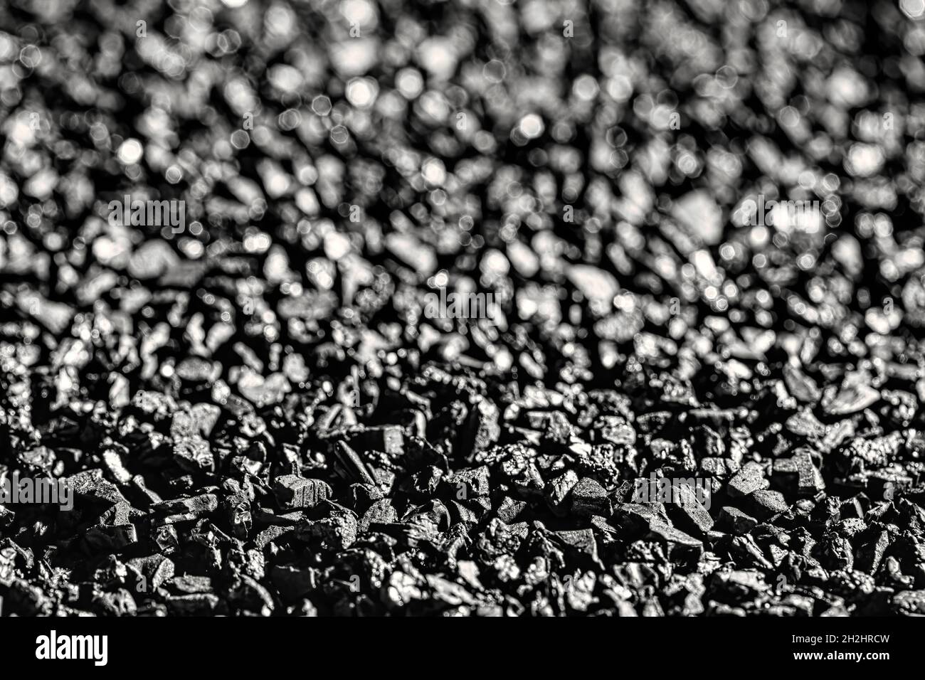 Close-up of black activated carbon texture. Coconut charcoal. Stock Photo