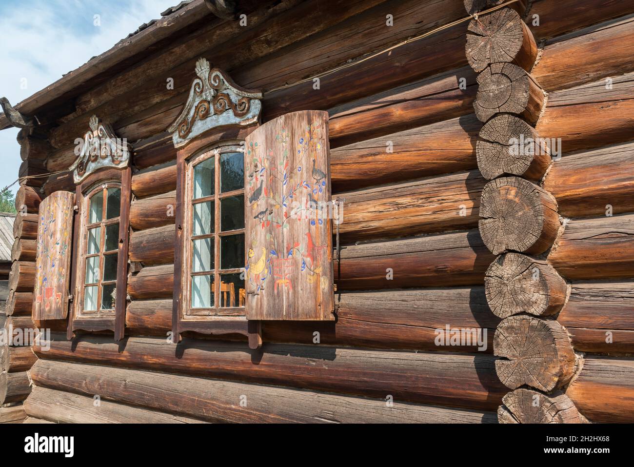 Traditional wooden house with folk art painted shutters in  the open-air Ethnographic museum near Ulan-Ude. Republic of Buryatia, Russia Stock Photo
