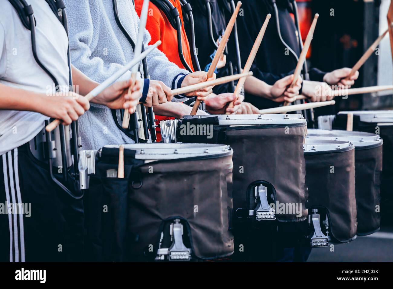 a section of a marching band drum line warming up before rehearsal Stock Photo