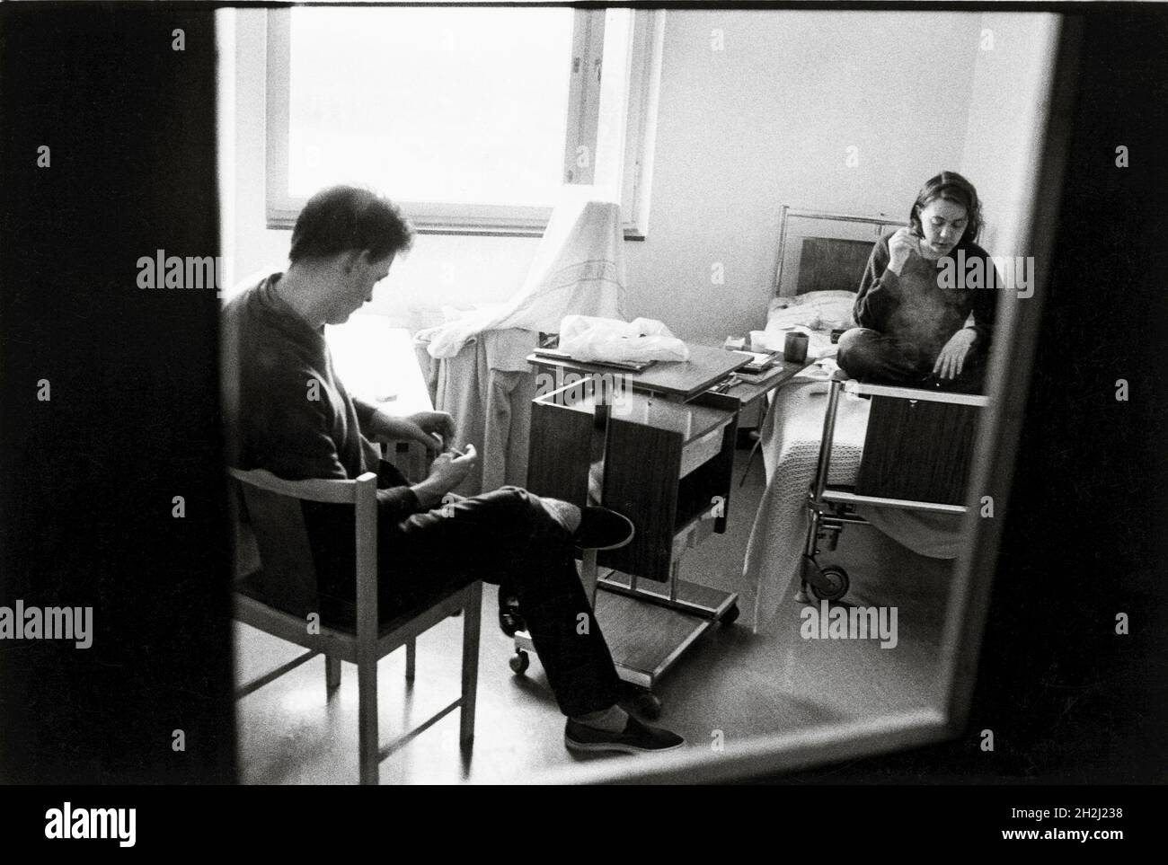 Female mental patient smoking and male psychiatric aide at mental hospital Beckomberga sjukhus in Stockholm, Sweden. Stock Photo