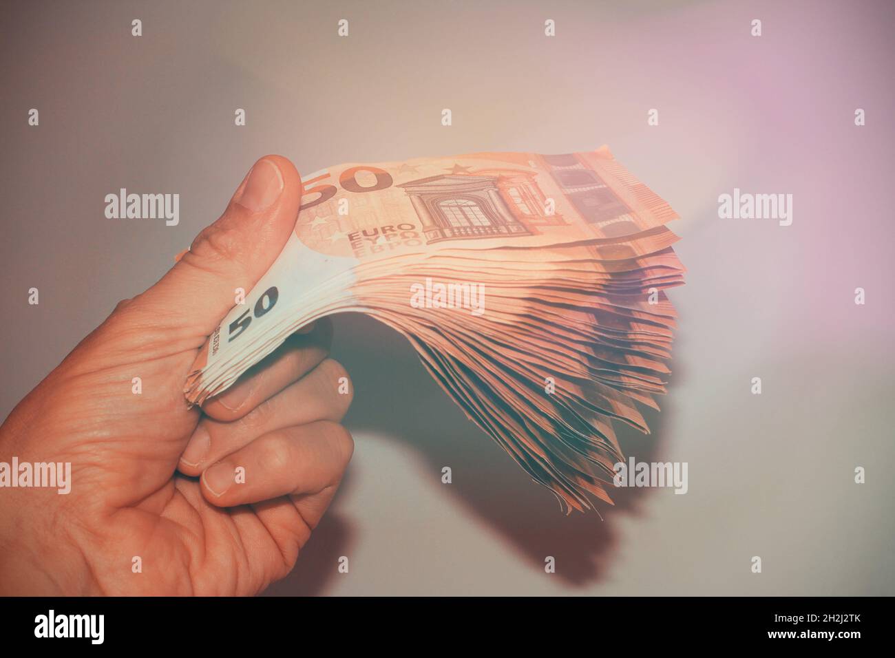 Money in hand with a flare. Stock Photo