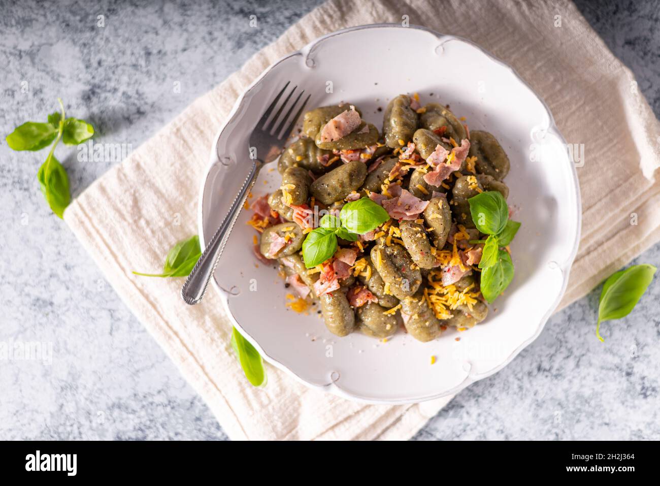 Homemade spinach gnocchi with ham and cheddar cheese Stock Photo Alamy