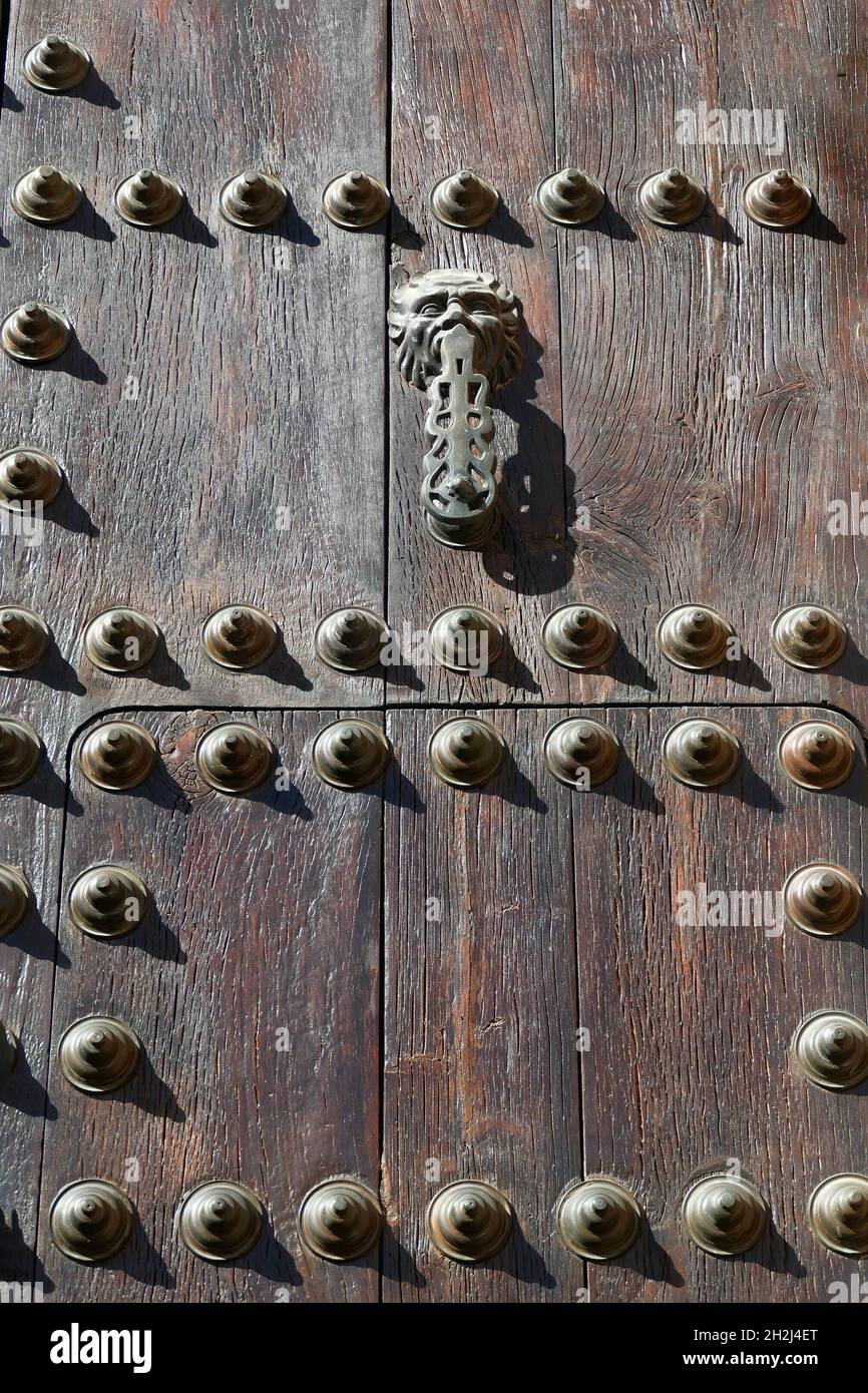 Old wooden door with metal ornaments and rivets, Ronda, Andalusia, Spain Stock Photo