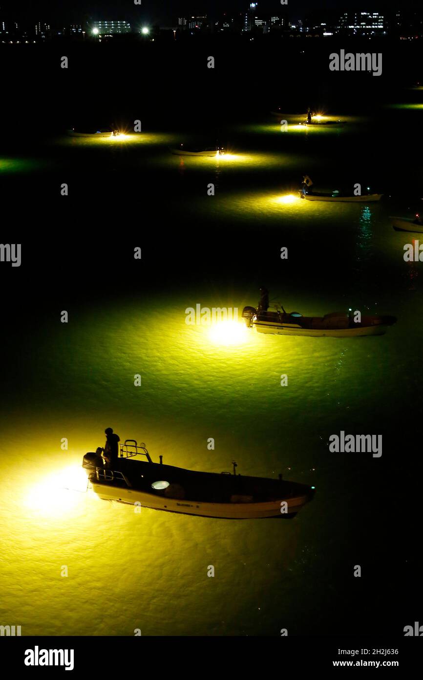 Fishermen on barges at night, fishing Shirasu eels in the Yoshino river, using lamps, Tokushima, Japan Stock Photo