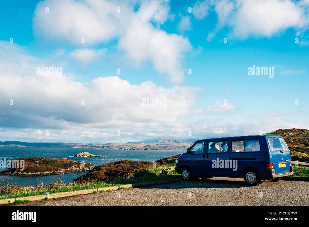 a blue campervan parked at drumbeg viewpoint on the nc500 road trip in scotland. Wild camping Stock Photo