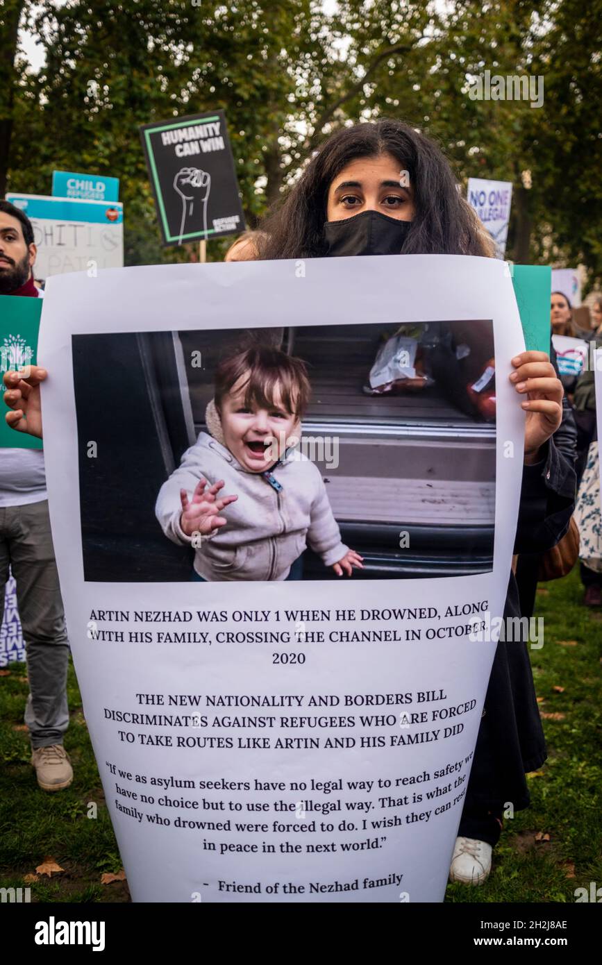 Woman holding a poster of a child refugee who drowned crossing the channel with his family in 2020, Refugee rally against the new Nationality and Borders Bill, Parliament Square, London, UK, 20/10/2021 Stock Photo