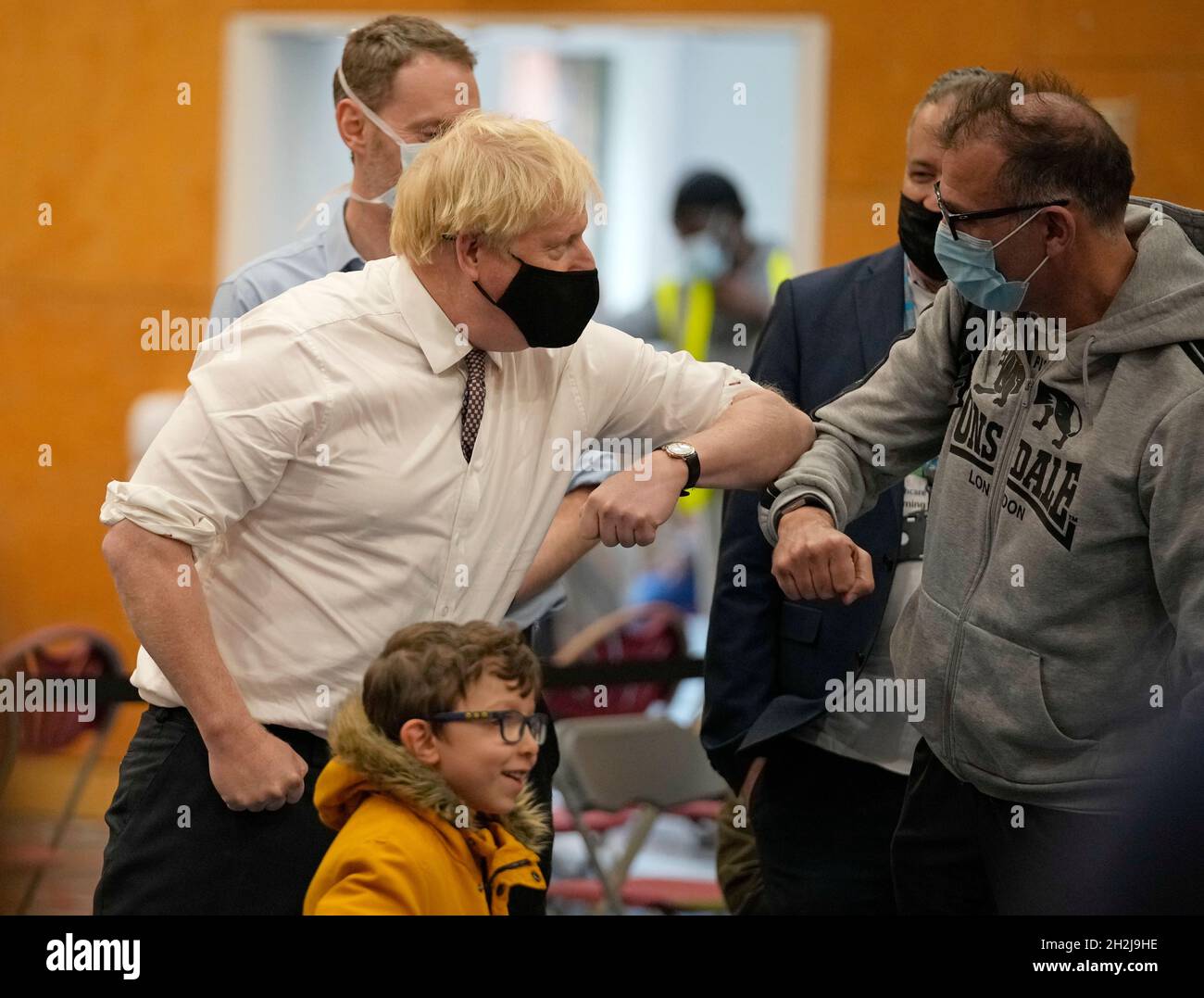 Prime Minister Boris Johnson (left) greets members of the public during a visit to the Covid-19 vaccine centre at the Little Venice Sports Centre in west London. Picture date: Friday October 22, 2021. Stock Photo