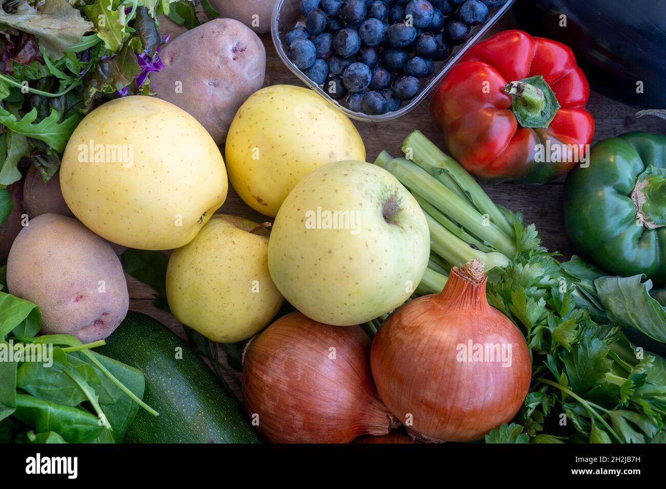 Fresh mixed bio vegetable and fruits in wooden basket harvested in the morning. Bio box from regional local farmers market concept Stock Photo