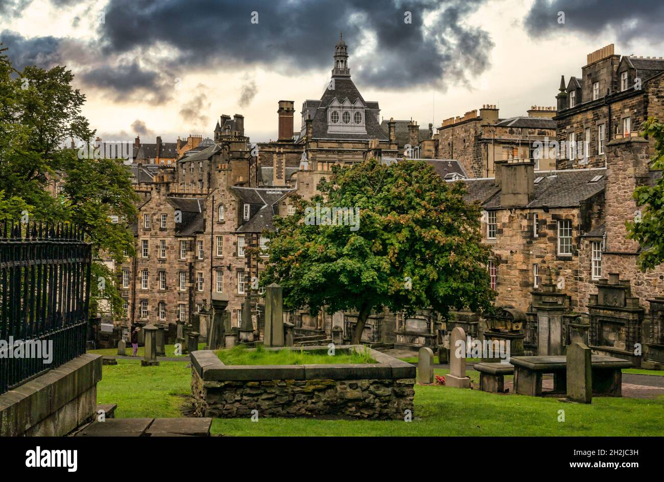 View from Greyfriar's Kirkyard with tombs and gravestones, and skyline and rooftops, including Central Library, of Old Town, Edinburgh, Scotland, UK Stock Photo
