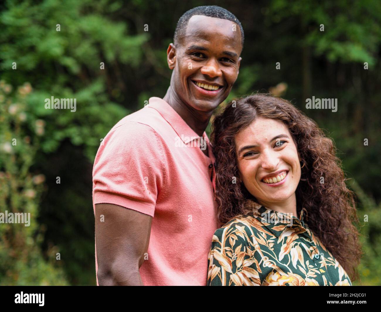 Happy mixed race couple in a forest Stock Photo