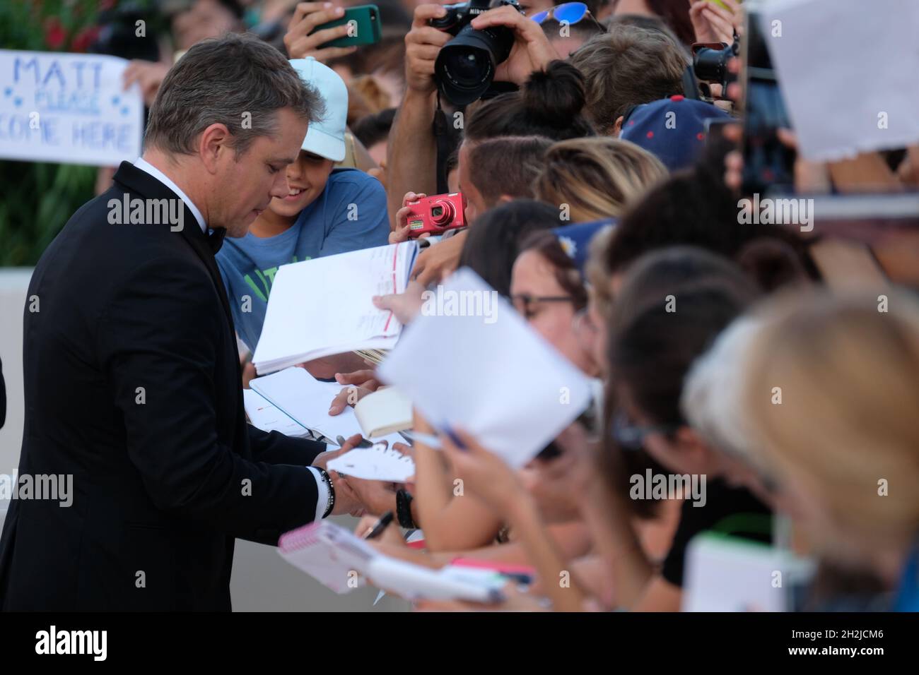 Actor Matt Damon signing autographs during a red carpet for the movie 'Downsizing' at the 74th Venice Film Festival in Venice, Italy August 30, 2017. Stock Photo