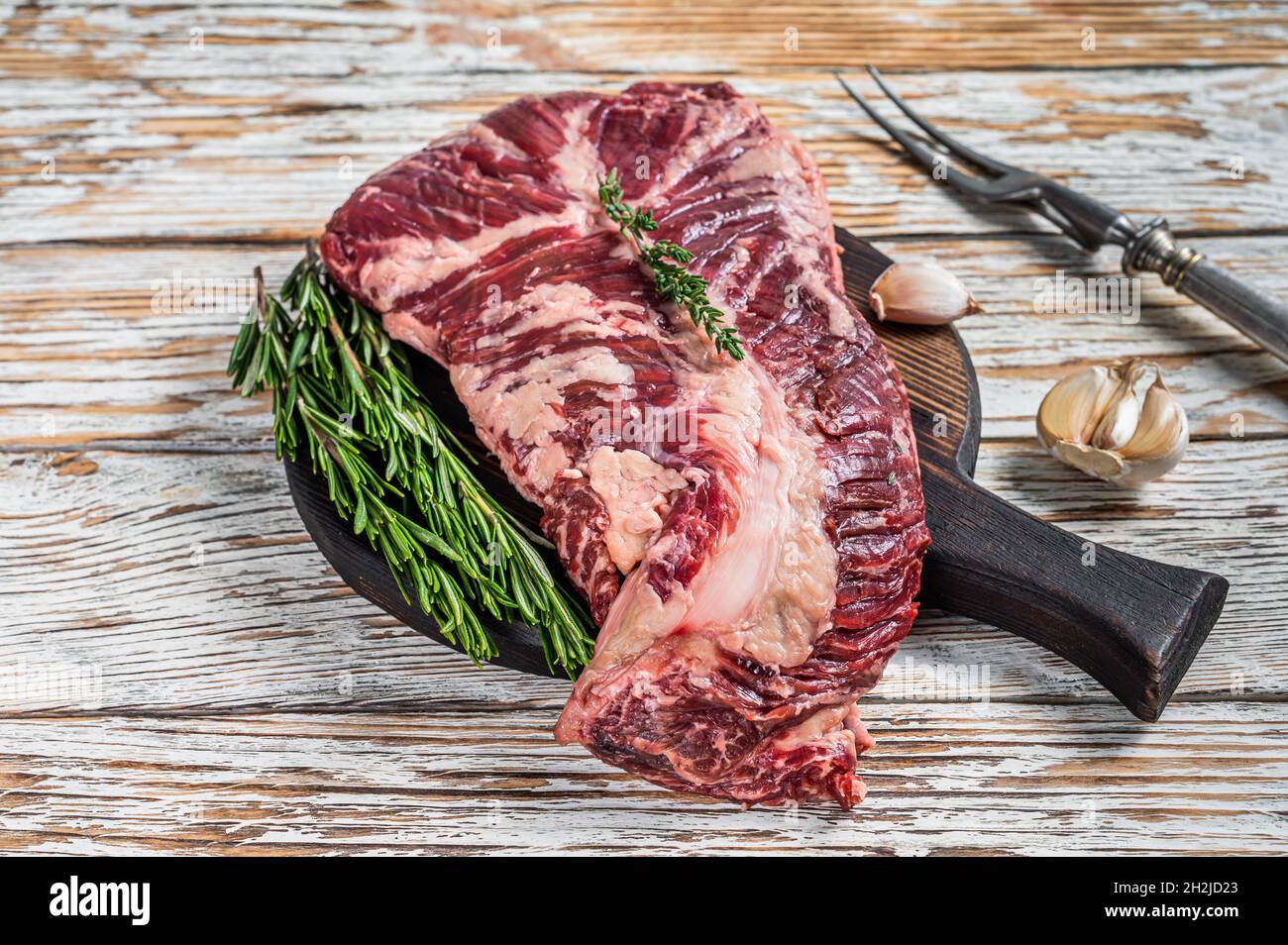 Butchers choice steak Onglet Hanging Tender beef meat on a cutting board. White wooden background. Top View Stock Photo