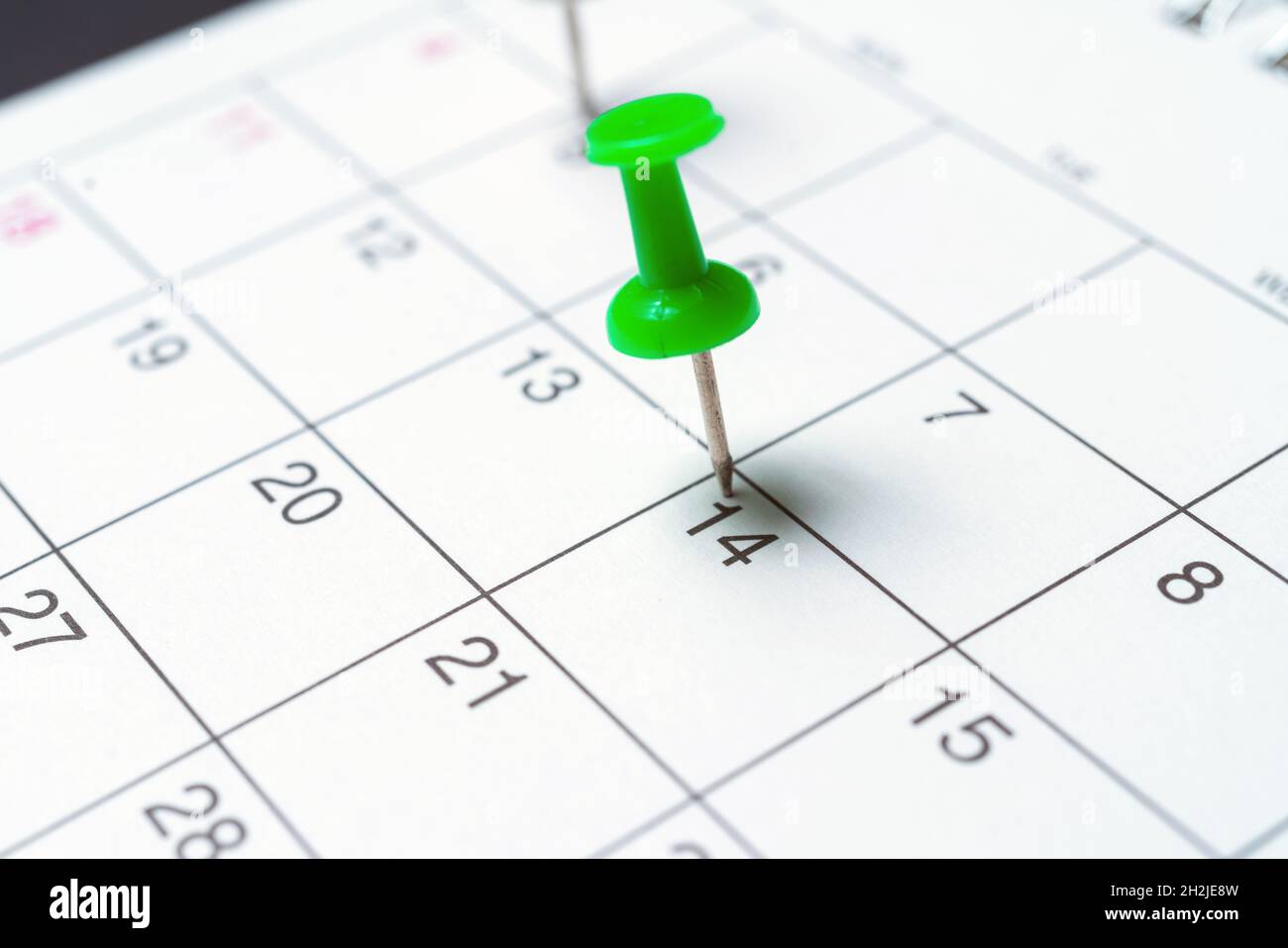 Paper calendar with important day pushpin. Close up. Stock Photo
