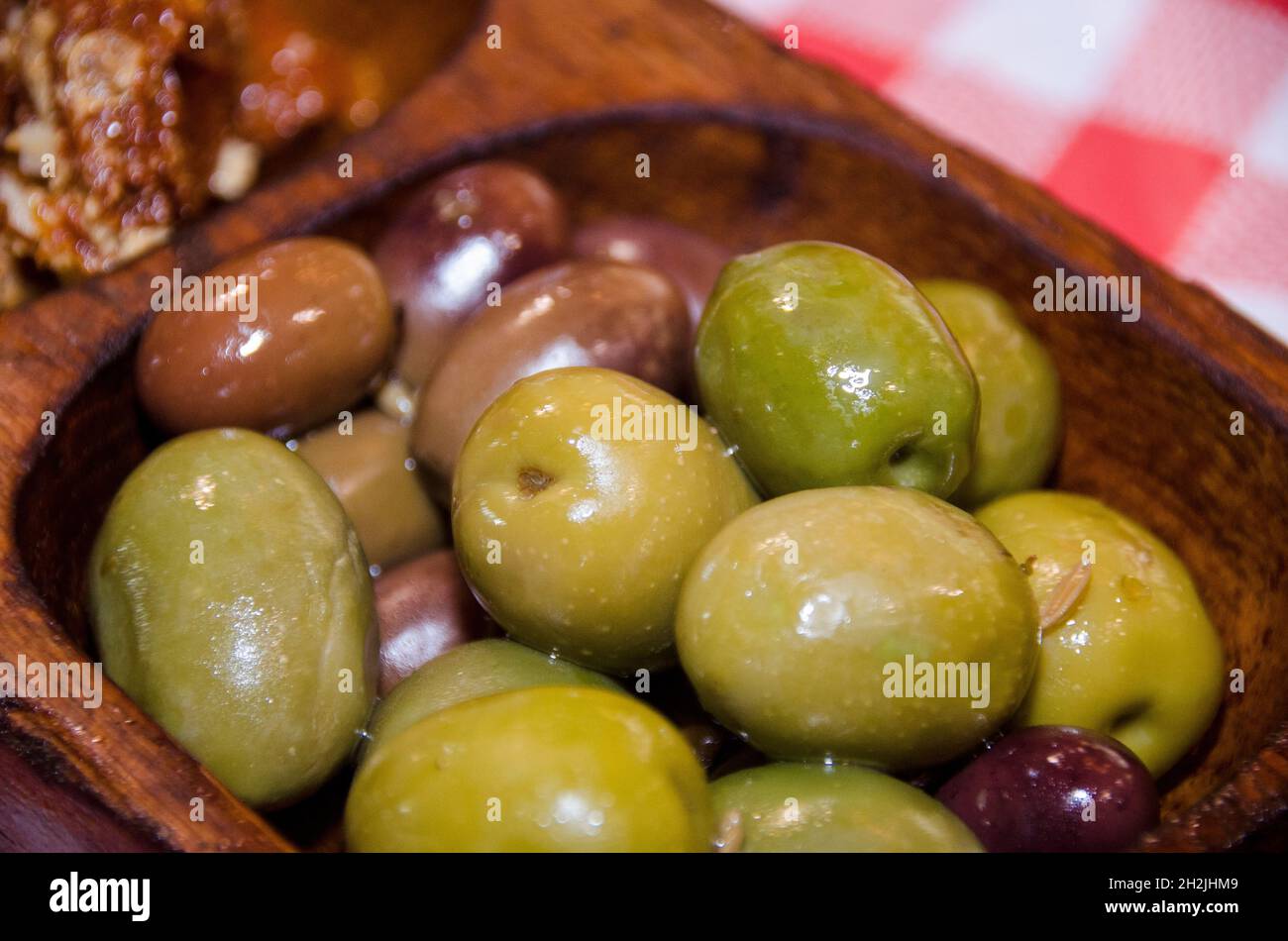 Bowls of Green and black olives served as appetizers Stock Photo