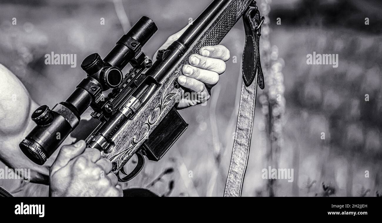 Hunter man. Hunting period. Male with a gun, rifle. Man is charging a