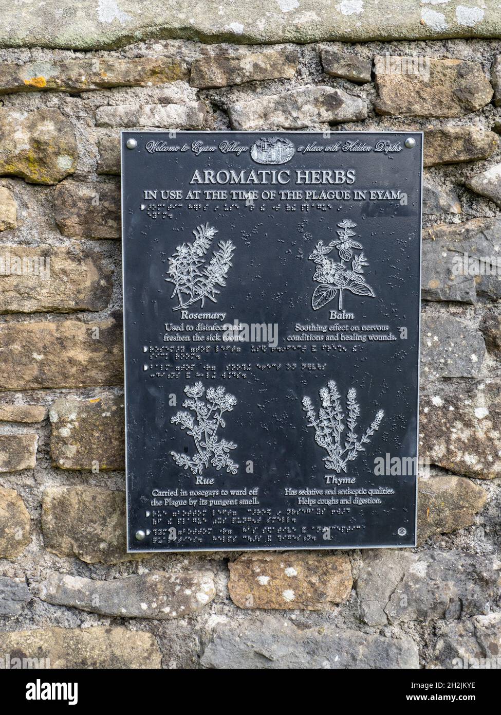 Metal sign indicating the herbs that were grown at the time of the 17th century plague in the village of Eyam, Derbyshire, UK Stock Photo