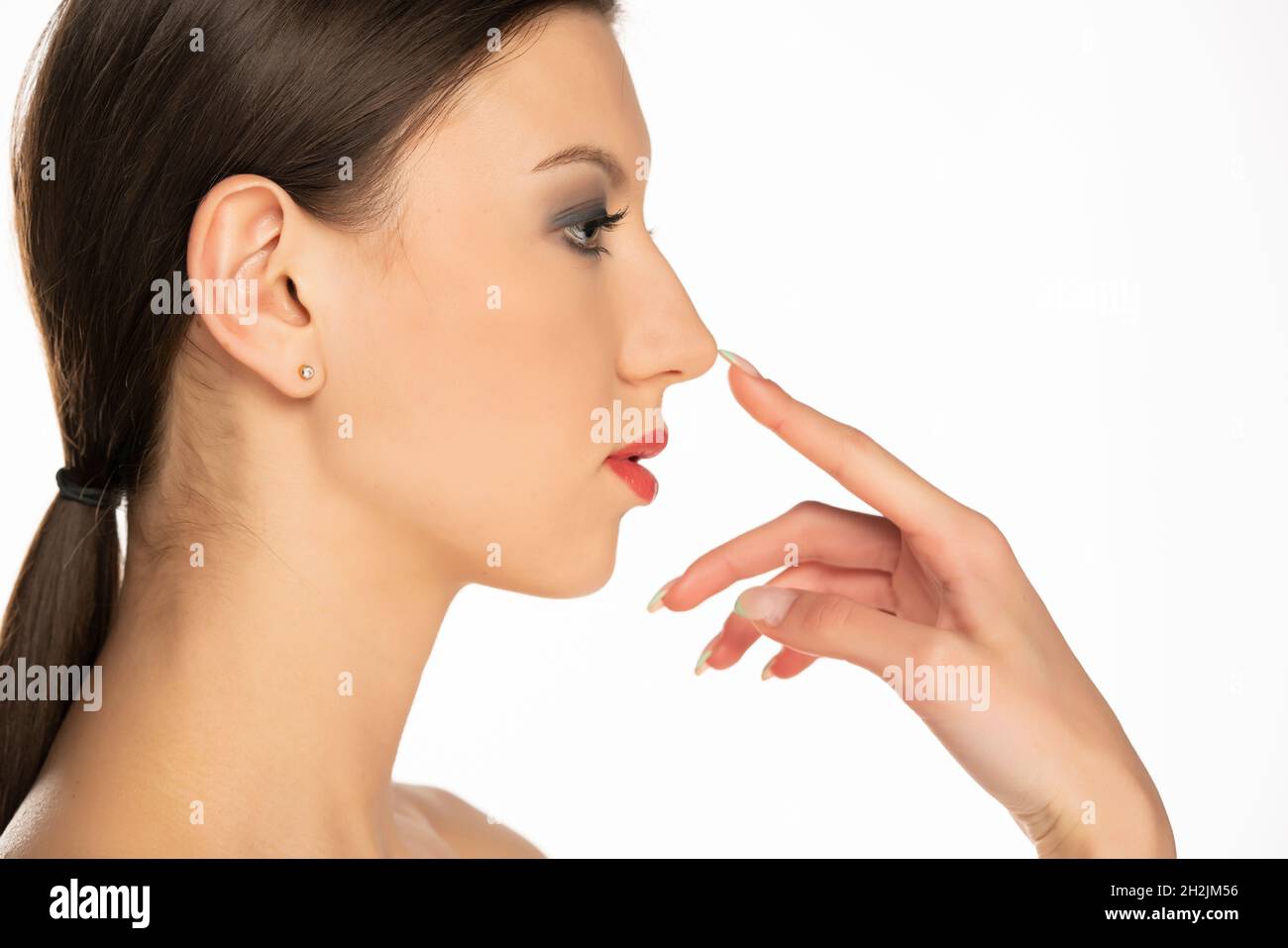 Finger touching nose eyes closed hires stock photography and images