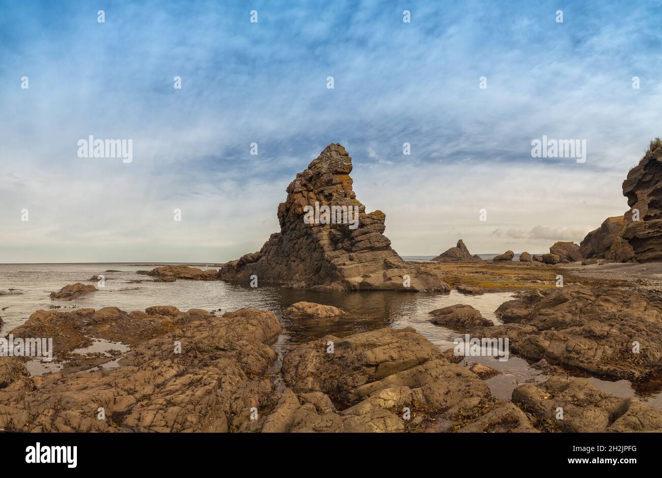 Sea rock landscape in a bay of Iturup island in Kuril islands, Russia.. Stock Photo