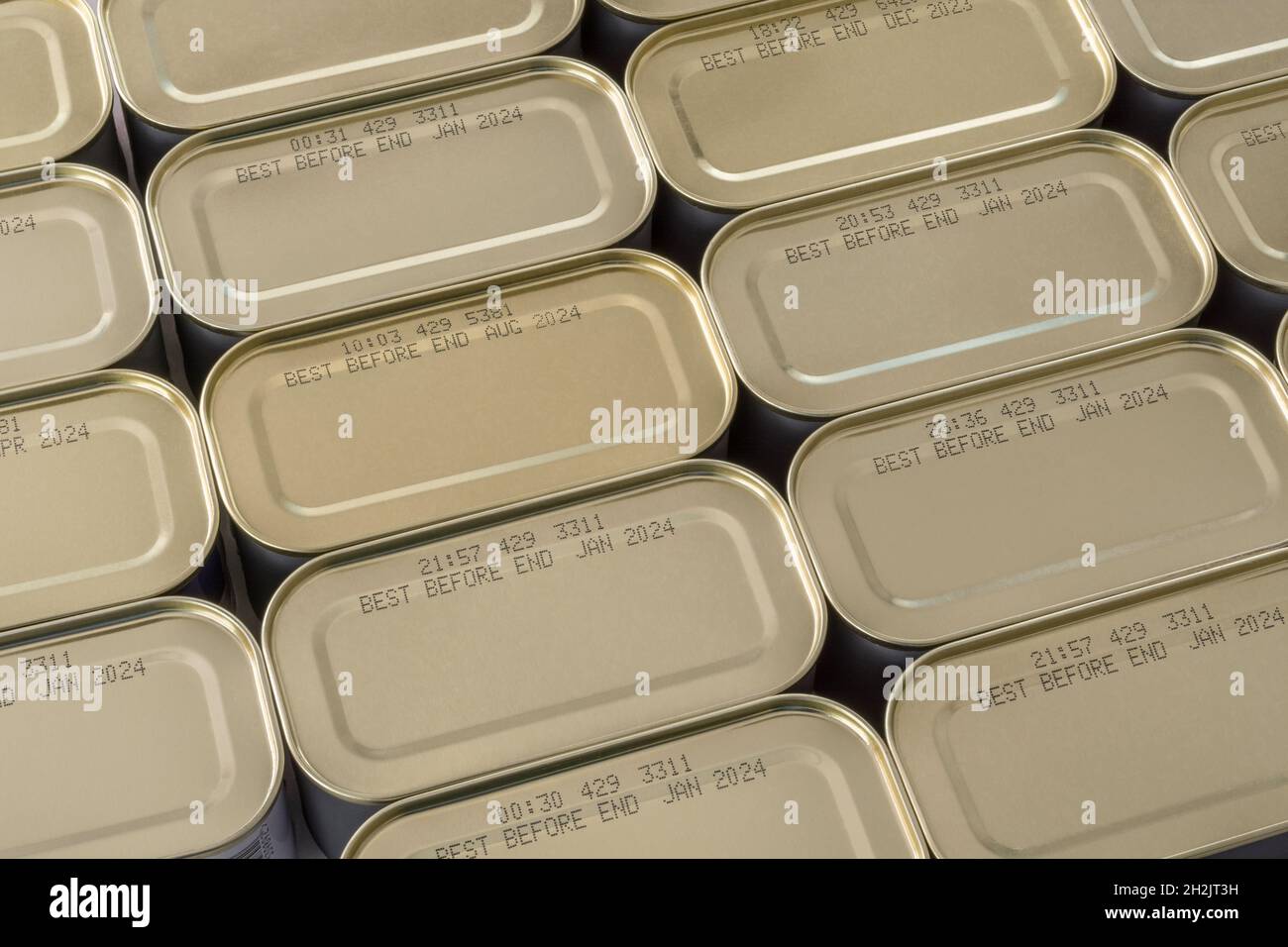 Abstract metal tin food cans with part of food Best Before Date visible. For food preservation, pandemic food shortages in UK, lockdown hoarding. Stock Photo