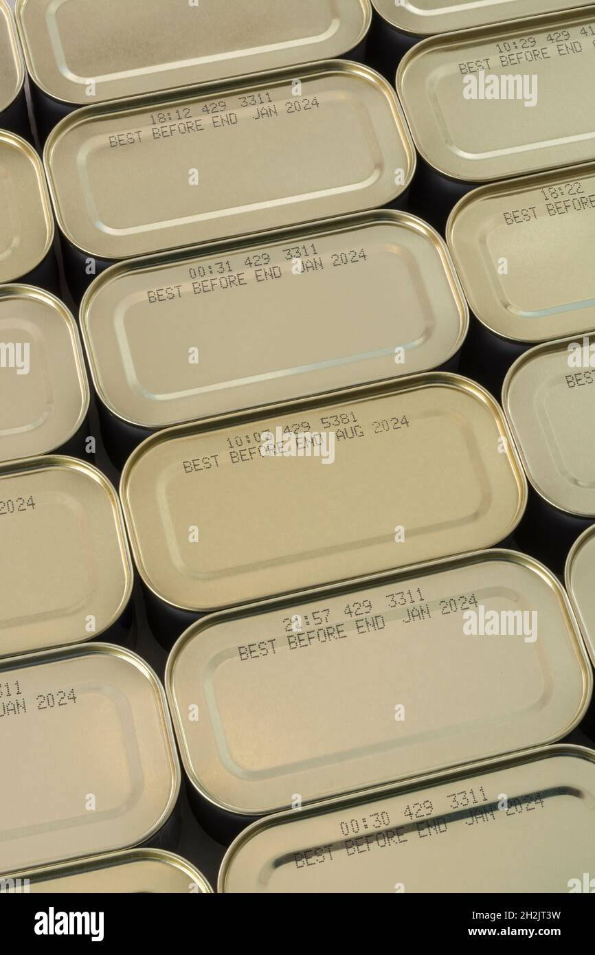 Abstract metal tin food cans with part of food Best Before Date visible. For food preservation, pandemic food shortages in UK, lockdown hoarding. Stock Photo