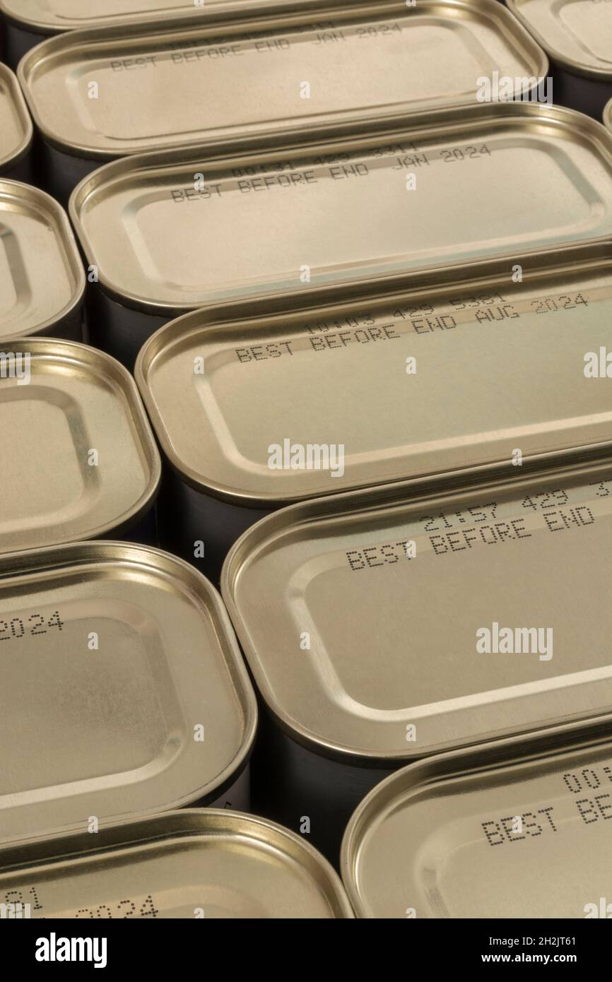 Abstract metal tin food cans with part of food Best Before Date visible. For food preservation, pandemic food shortages in UK, lockdown hoarding. Stock Photo