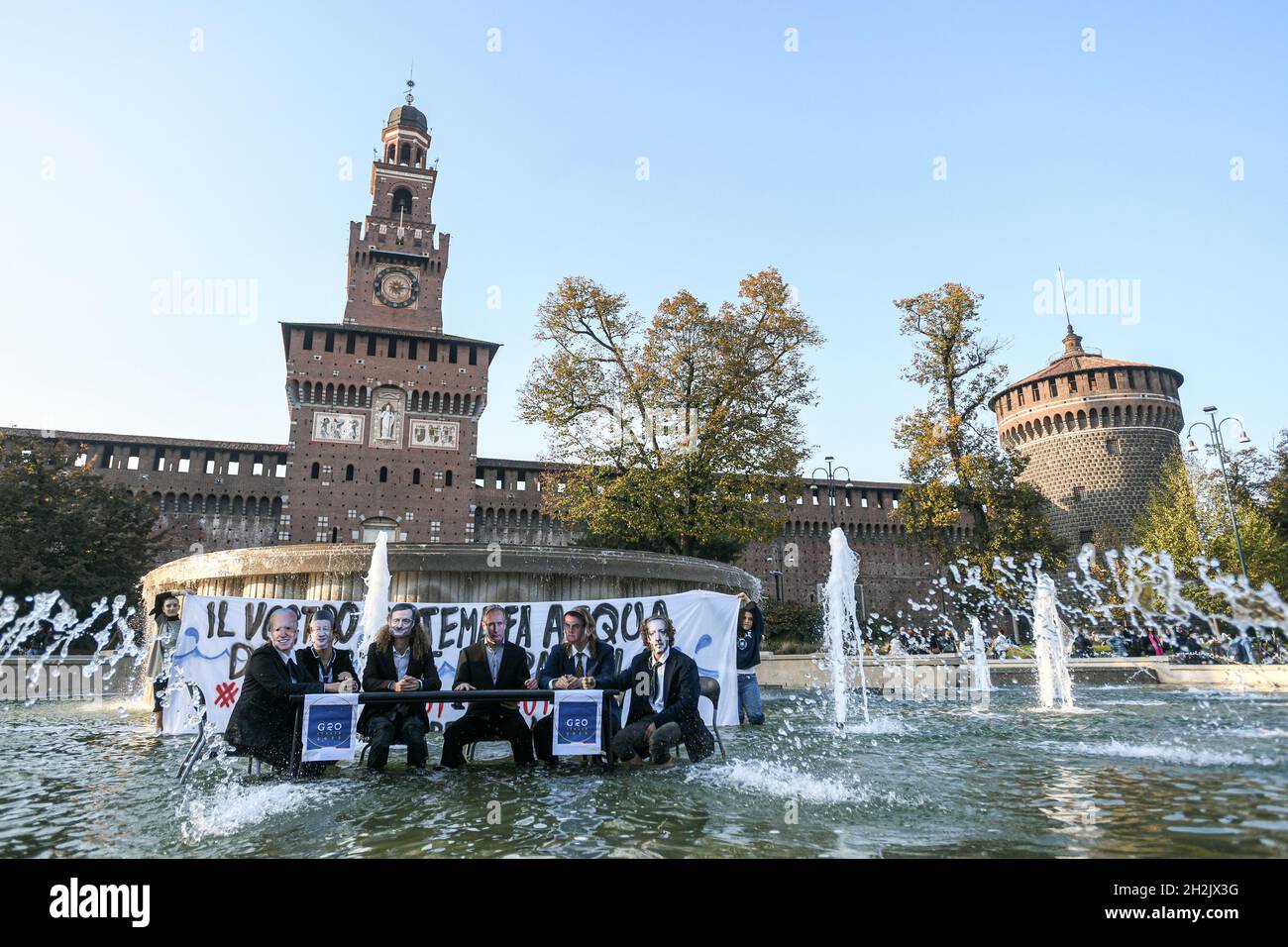 Milan, Italy. 22nd Oct, 2021. Milan, Italy - 22 October 2021: Fridays For Future climate activists wearing masks depicting world leaders, stage a flash mob in front of the Sforza Castle in preparation of the G20 Credit: Piero Cruciatti/Alamy Live News Stock Photo